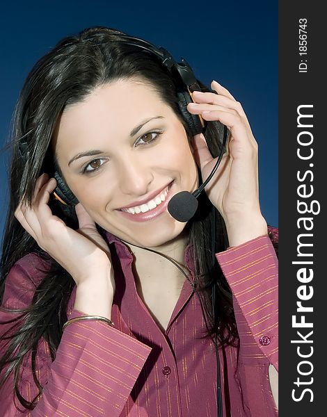 Smiling young woman of a call center, on blue background. Smiling young woman of a call center, on blue background