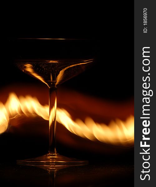 Luxurious wine glass on a glass table with flames. Luxurious wine glass on a glass table with flames.