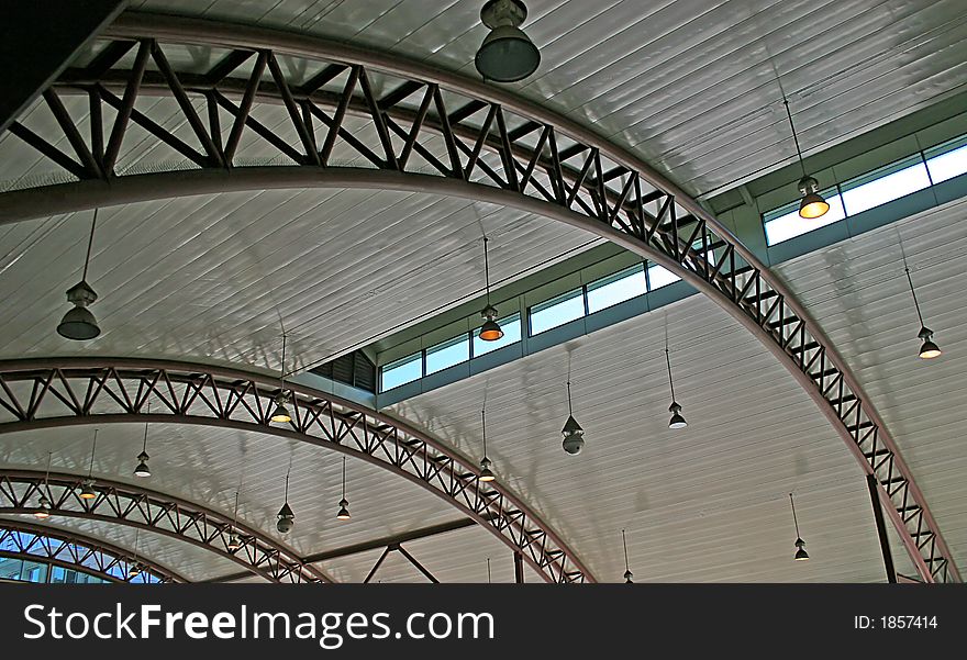 Steel arches supporting curved concrete roof