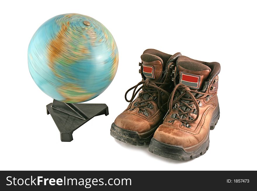 Brown boot next to a rotating globe
