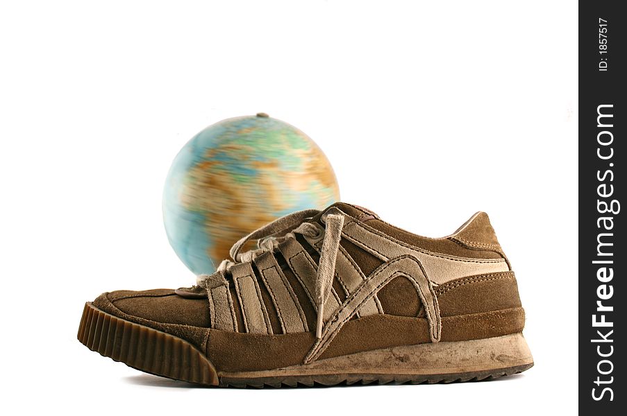 Sport shoes next to a globe