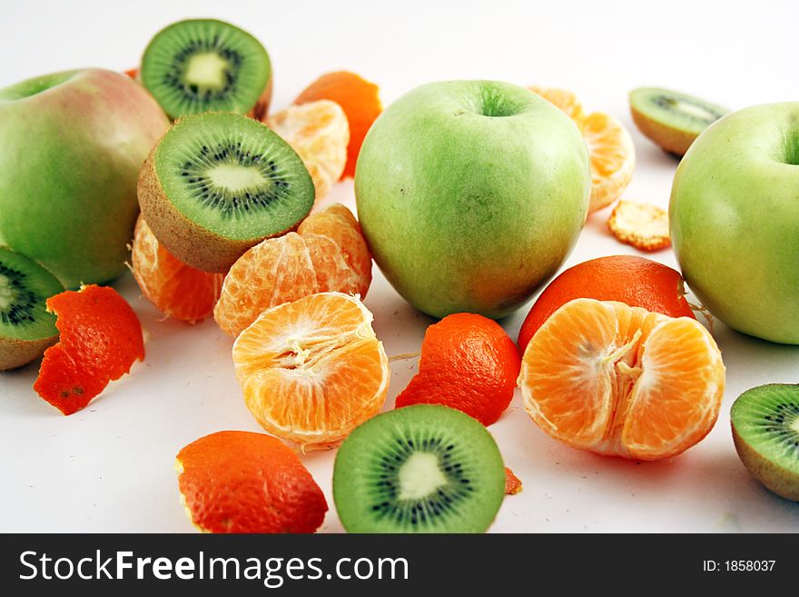 Peeled mandarin, apples and kiwies isolated on white background