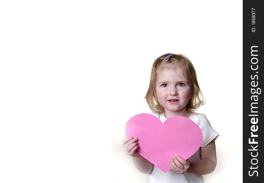 Little girl dressed in white holding a valentine heart. Little girl dressed in white holding a valentine heart