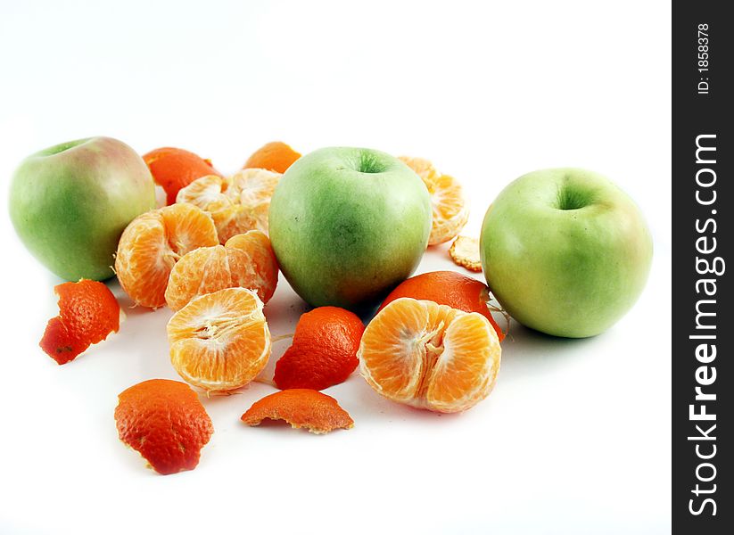 Peeled mandarin and apples isolated on white background