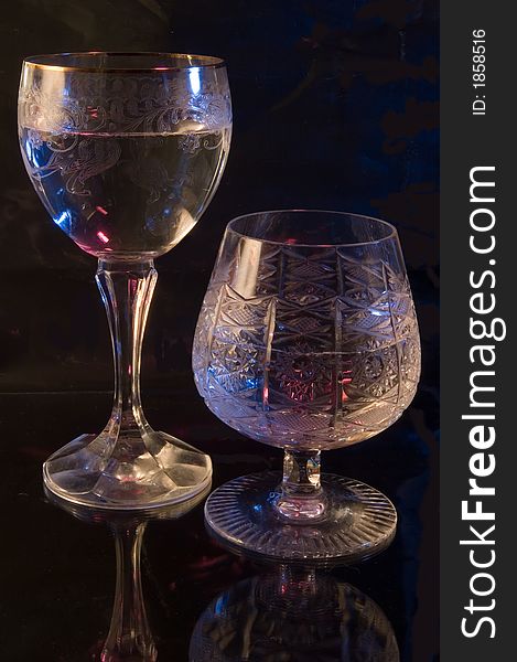 Two glasses with a drink on a black background