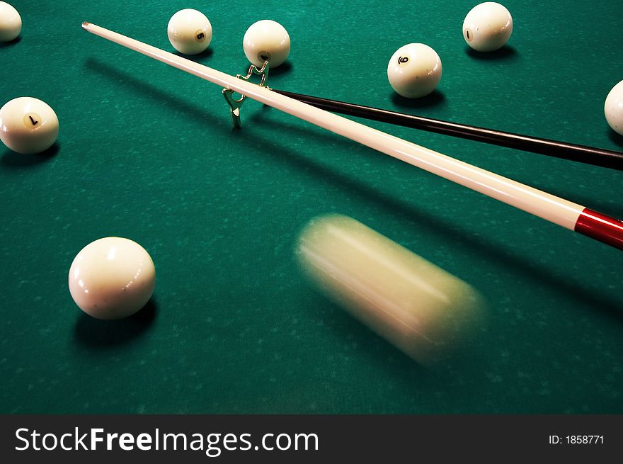 White spheres and cue on a green billiard table