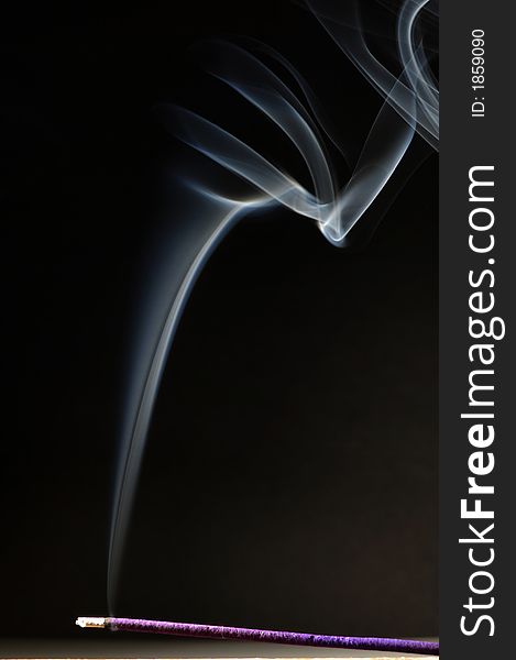 Joss stick and white smoke on black background. Joss stick and white smoke on black background