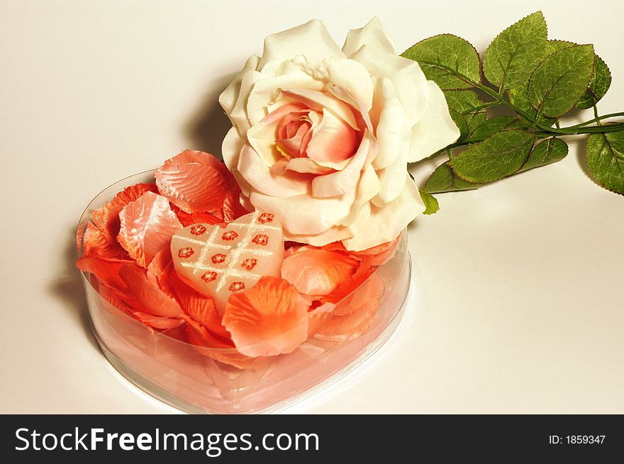 White pink rose with pink petals in clear box with heart candle mother's day. White pink rose with pink petals in clear box with heart candle mother's day