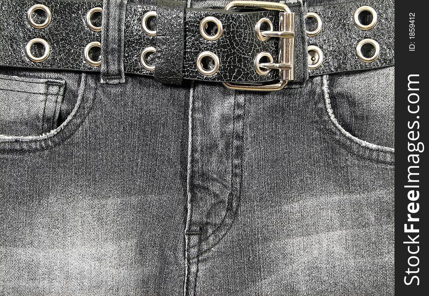 Closeup of black denim jeans with black leather belt and metal buckle. Closeup of black denim jeans with black leather belt and metal buckle.