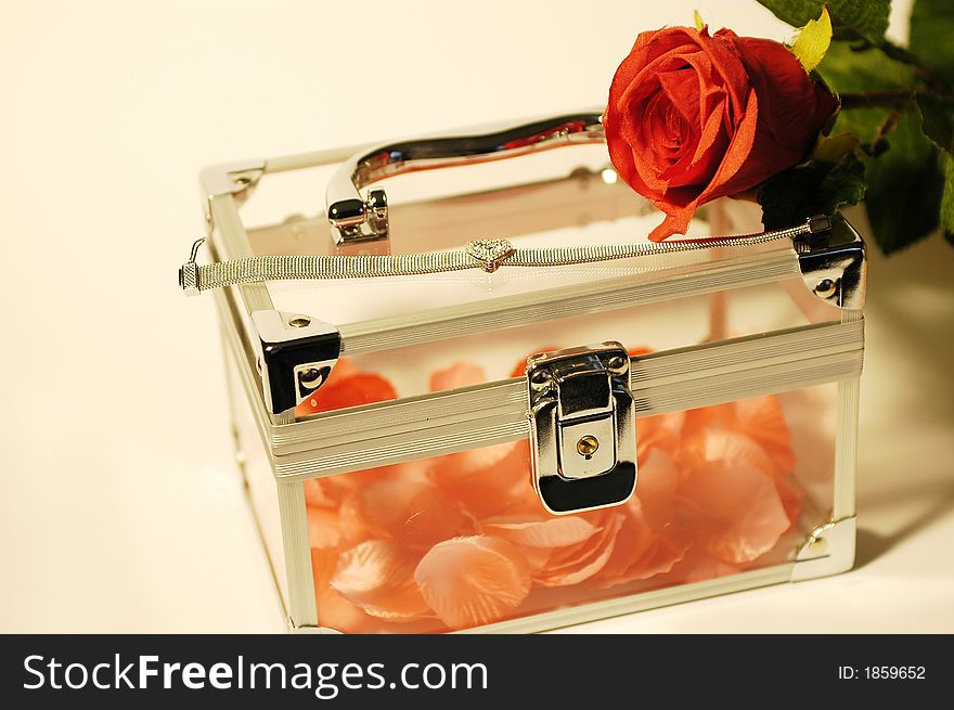 Pink rose petals in jewelry box silver bracelet red rosebud mother's day. Pink rose petals in jewelry box silver bracelet red rosebud mother's day