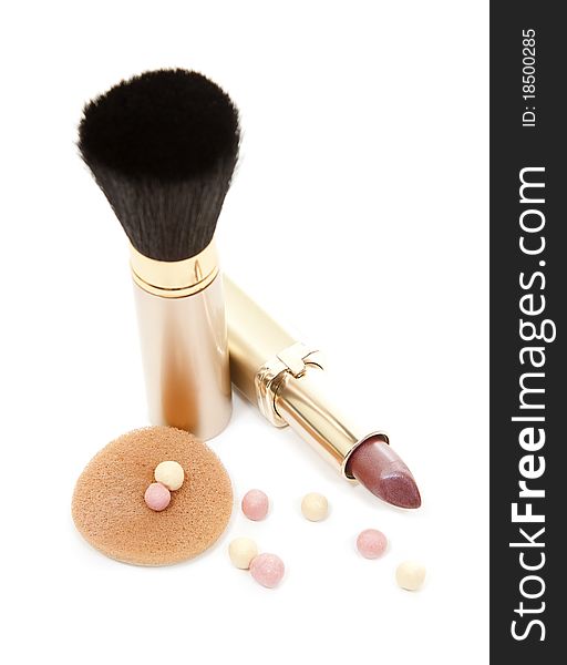 Isloated gold cosmetics accesories, brush and lipstick. Isloated gold cosmetics accesories, brush and lipstick
