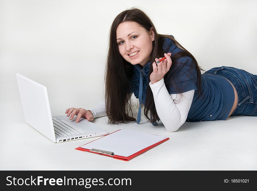 Girl lying on the floor and working on laptop. Girl lying on the floor and working on laptop