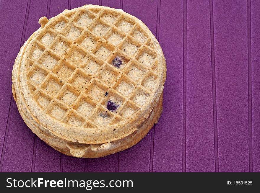 Frozen Blueberry Waffles Close Up on Purple.
