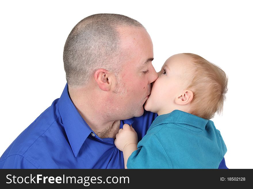 Baby boy kissing his dad holding onto his shirt. Baby boy kissing his dad holding onto his shirt