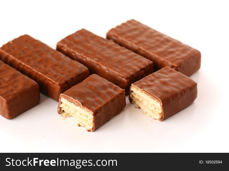 Row of a few chocolate wafers on white background