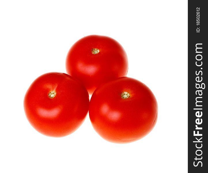 Three fresh tomatoes on white background close-up (isolated). Three fresh tomatoes on white background close-up (isolated).