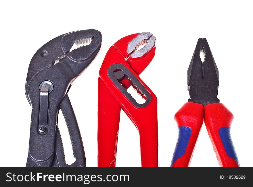 Alligator wrenches and pliers on white background close-up (isolated). Alligator wrenches and pliers on white background close-up (isolated).