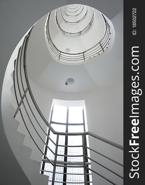 White winding staircase in a building