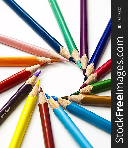 Circle of colored pencils with white isolation. This pictures represents some colored pencils. Circle of colored pencils with white isolation. This pictures represents some colored pencils.