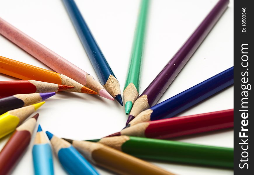 Circle of colored pencils with white isolation. This pictures represents some colored pencils. Circle of colored pencils with white isolation. This pictures represents some colored pencils.