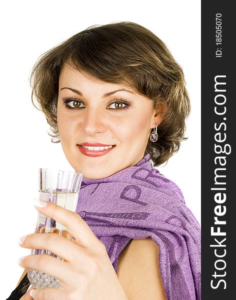 Attractive young woman face in purple scarf with glass of sparkle wine isolated on the white. Attractive young woman face in purple scarf with glass of sparkle wine isolated on the white.