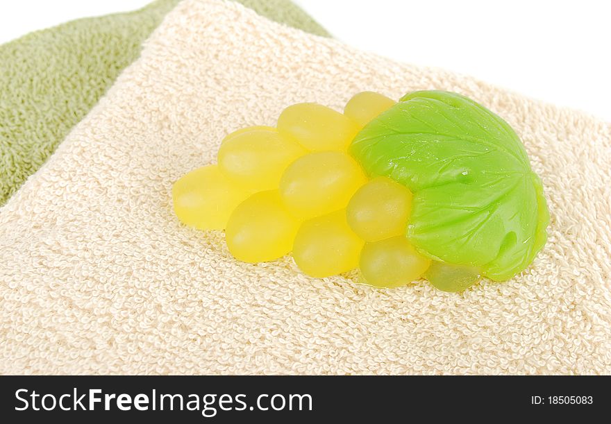 Natural green grape soap and towels on white background. Natural green grape soap and towels on white background.