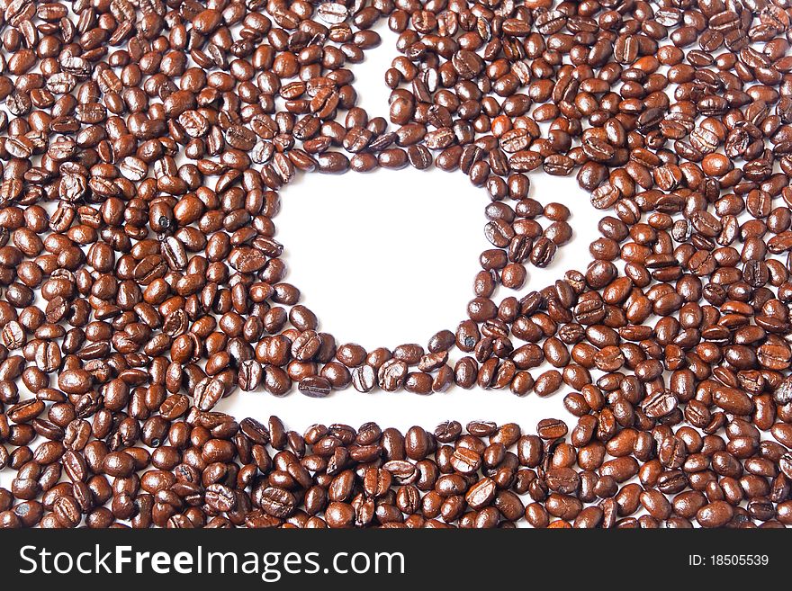 White coffee cup in many brown coffee beans for background