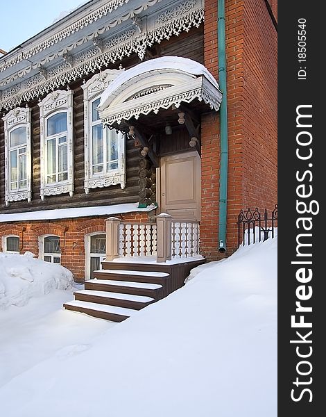 Winter. Snow lies on  porch of  old house, Russia.