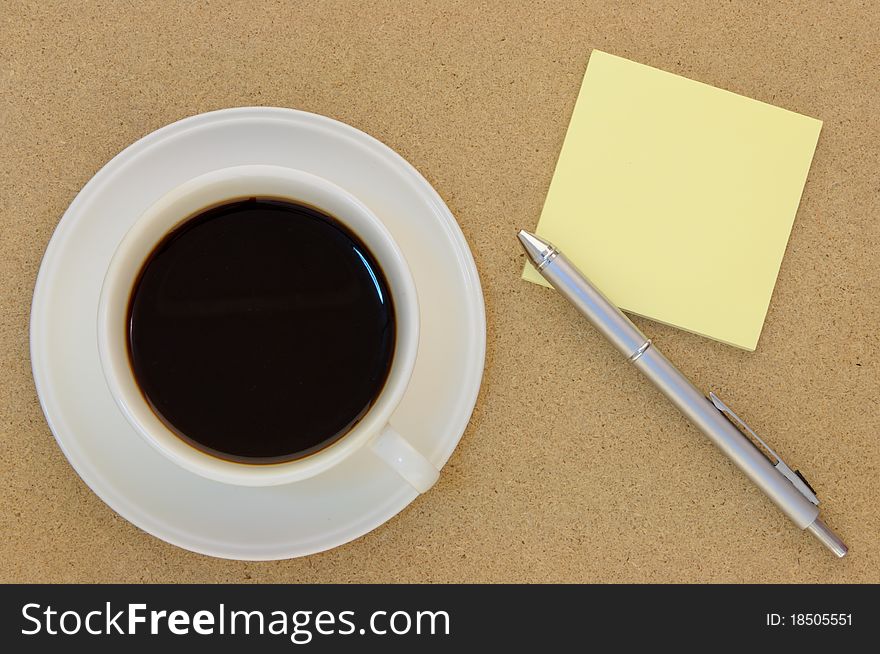 Blank postit note and coffee on table