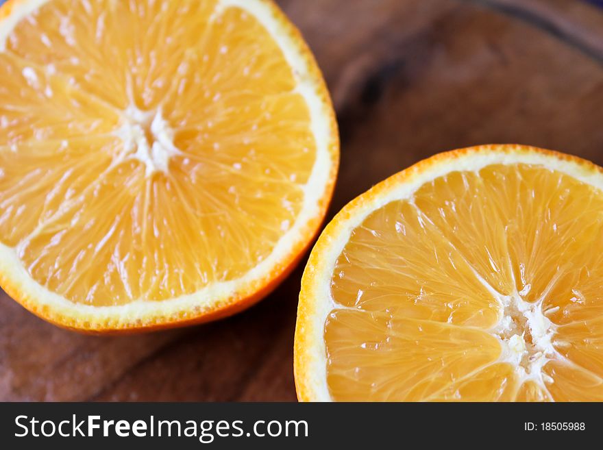 Halves of oranges on a wooden board