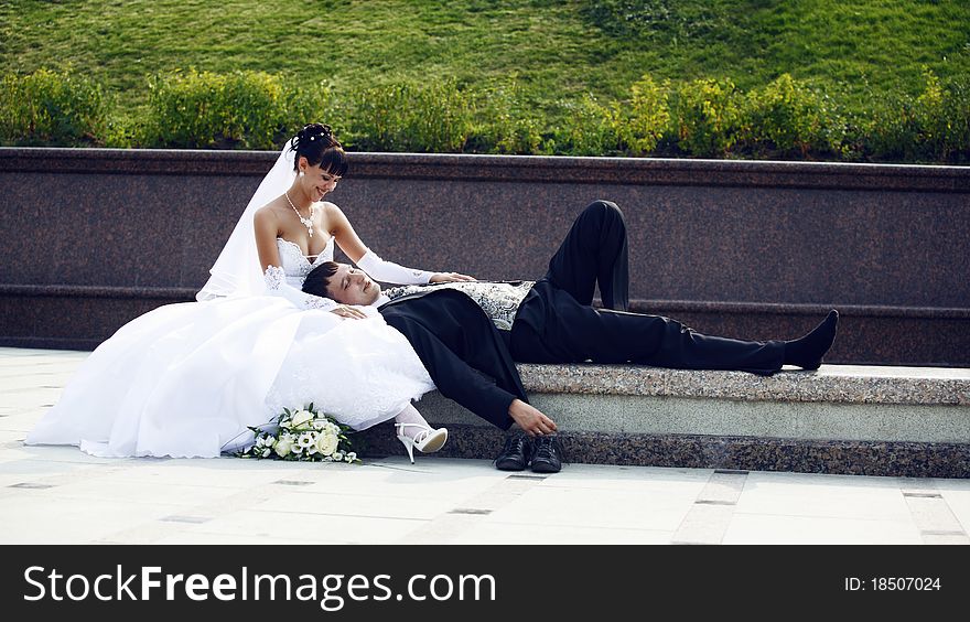 Bride sitting and groom laying. Bride sitting and groom laying