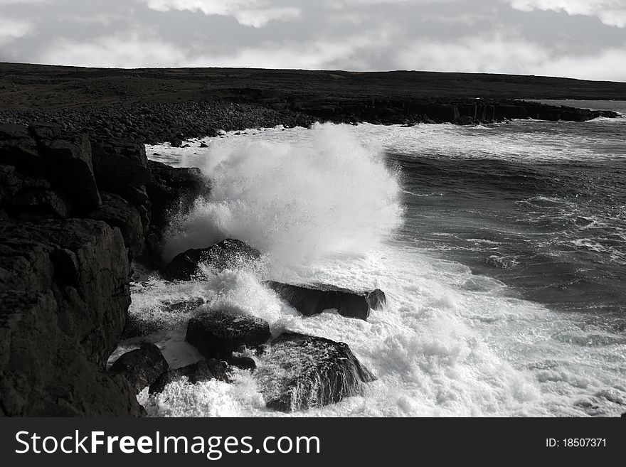 Giant storm waves crashing on coastline cliffs