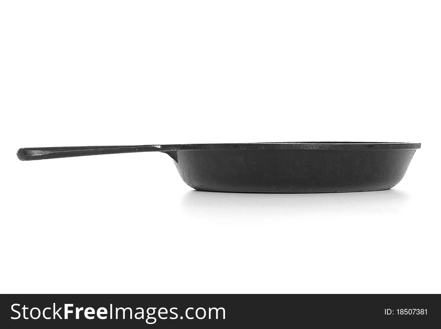 Cast-iron frying pan with shadow isolated on white background