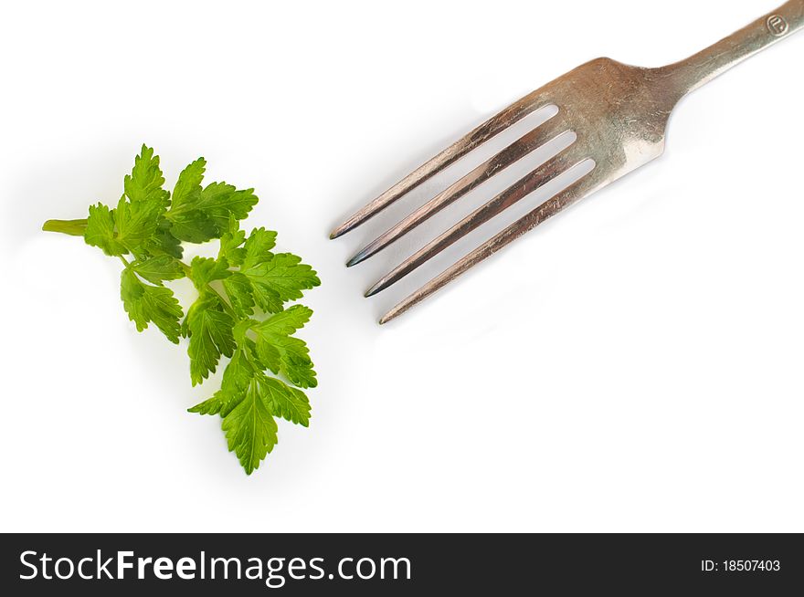 A parsley and a fork isolated on white background. A parsley and a fork isolated on white background