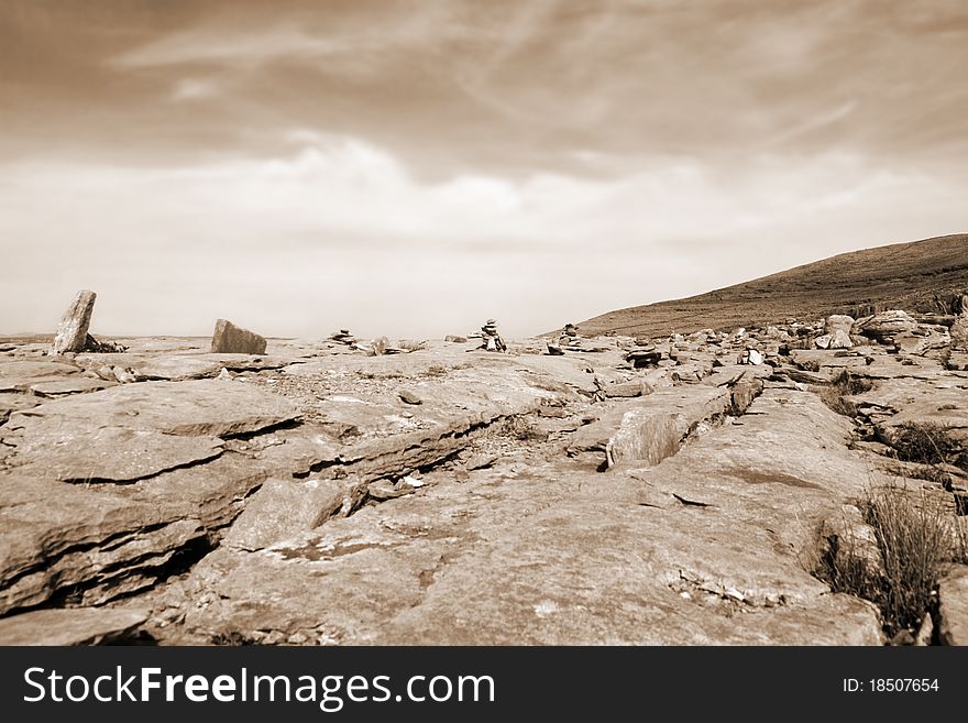 Sepia rocks in hilly rocky burren landscape