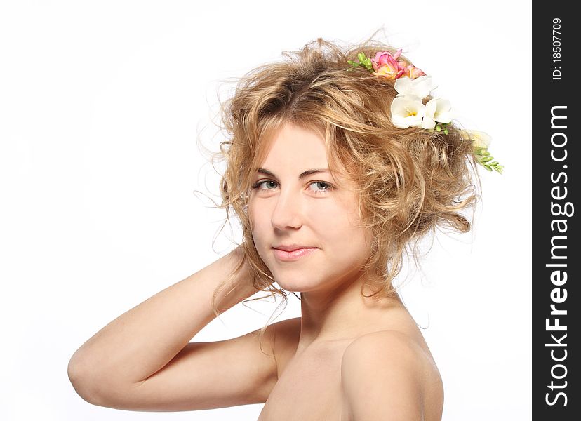 Portrait of the beauty young blond girl with freesia in her hair
