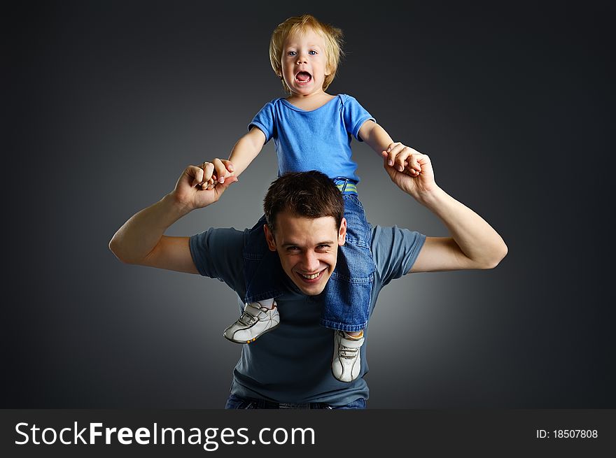 The portrait of a cheerful little boy and his father. The portrait of a cheerful little boy and his father