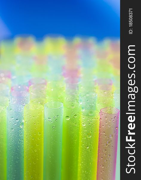 Clean and wet plastic straws for juice. Enhanced colors gives a joyful and fresh look and the blue&background is a good place for text. Clean and wet plastic straws for juice. Enhanced colors gives a joyful and fresh look and the blue&background is a good place for text.