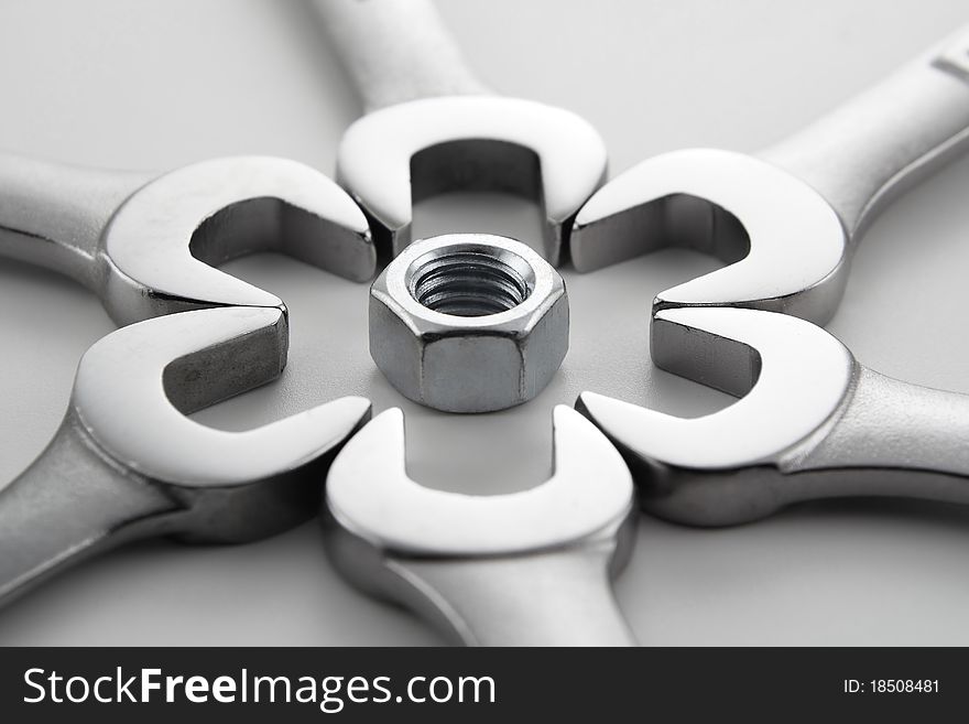 Wrenches and hardware in various patterns on a white background. Wrenches and hardware in various patterns on a white background