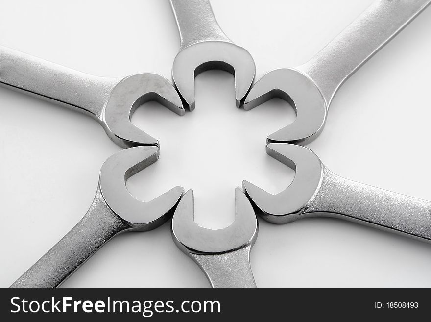 Wrenches and hardware in various patterns on a white background. Wrenches and hardware in various patterns on a white background