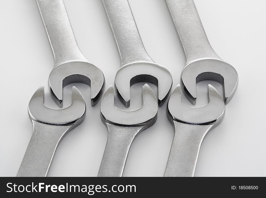 Wrenches and hardware in various patterns on a white background. Wrenches and hardware in various patterns on a white background