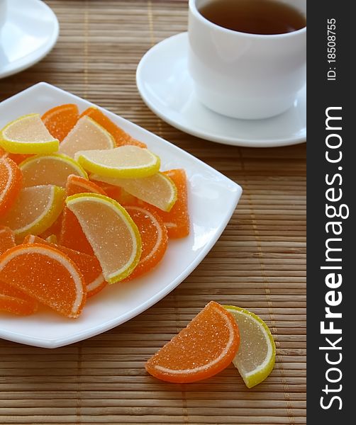 Colour fruit candy and cup of tea on a table. Colour fruit candy and cup of tea on a table.