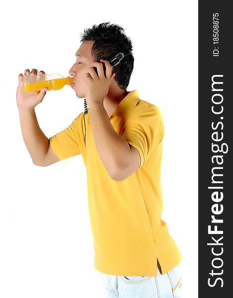 a young man was drinking a bottle of orange juice