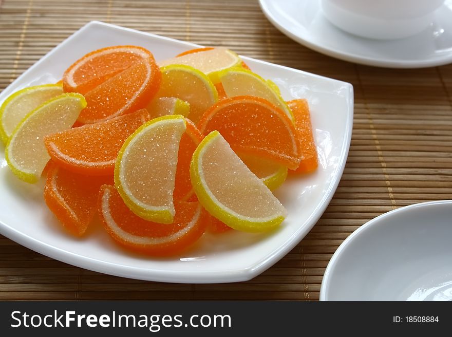 Colour fruit candy and cup of tea on a table. Colour fruit candy and cup of tea on a table.