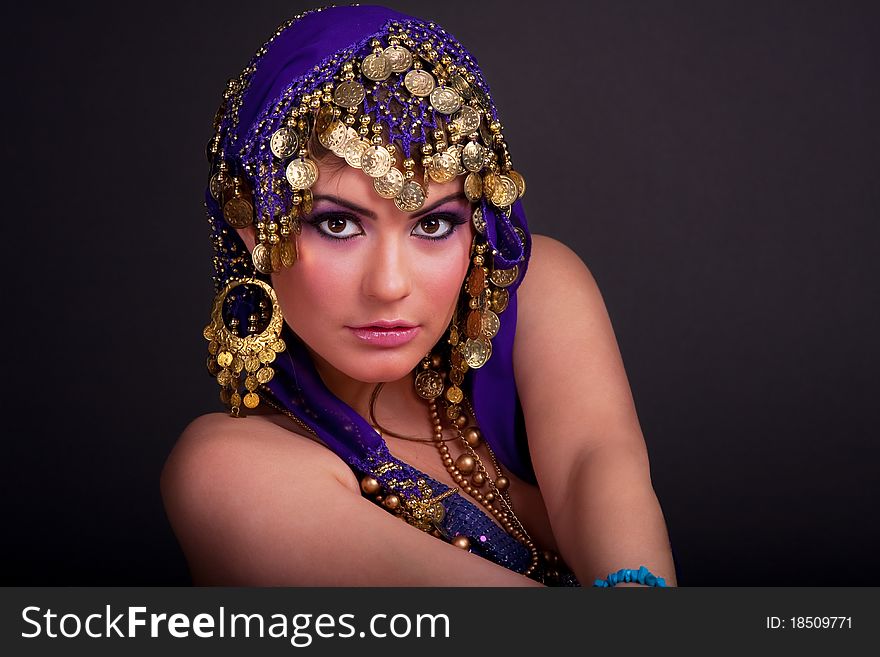 Beautiful girl in a stylized ethnic costume and shawl