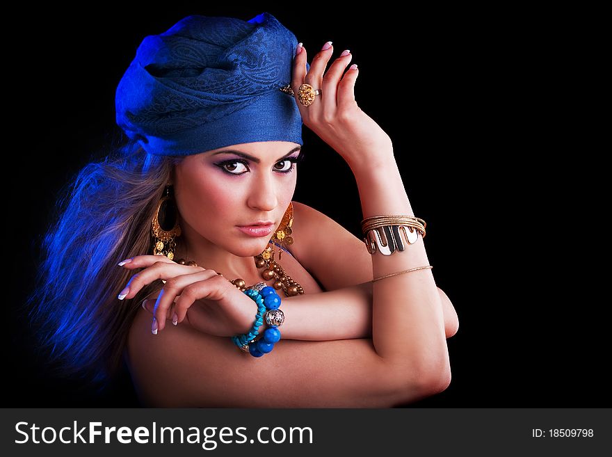 Beautiful girl in a turban and a stylized ethnic costume