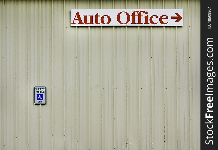 Signs on a building with aging rusting metal walls. Signs on a building with aging rusting metal walls.