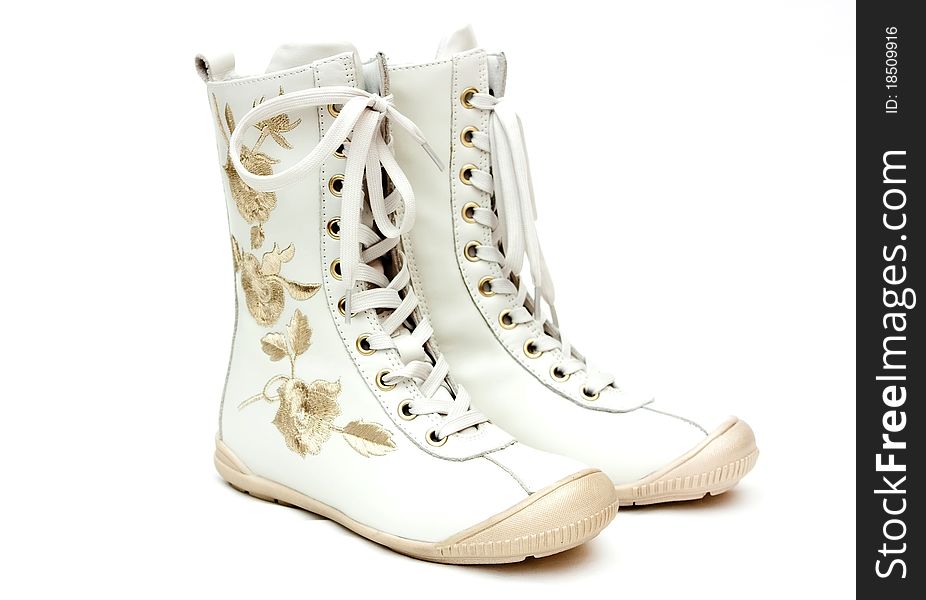 Pair of white female boots on the white background
