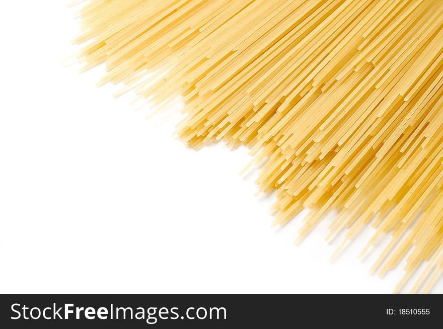 Uncooked spaghetti close-up on a white background