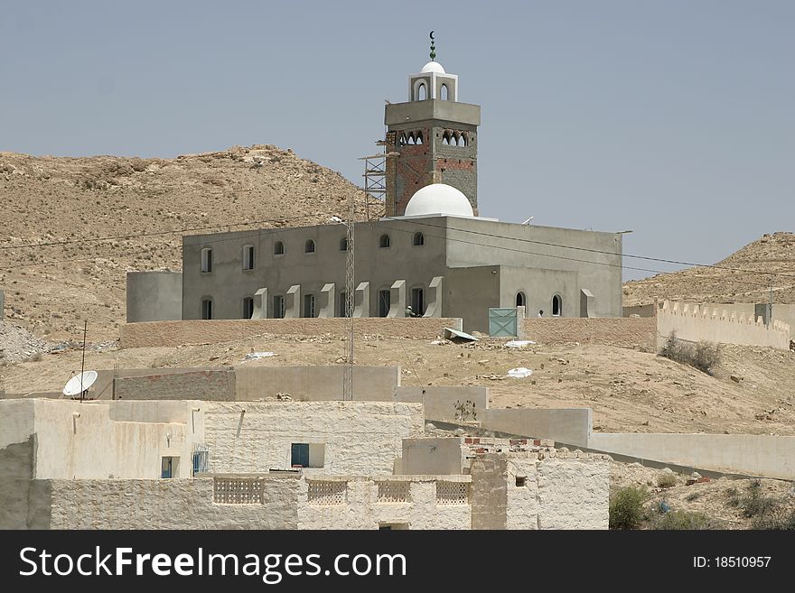 Mosque with Arab style minaret in the desert oasis in Tunisa. Mosque with Arab style minaret in the desert oasis in Tunisa